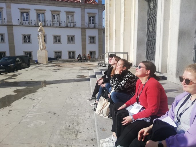 Enjoying the sun on the steps in front of the Faculty of Arts and Humanities